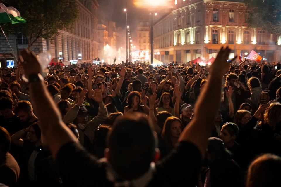 People gather at the Republique plaza in Paris after the second round of the legislative election on Sunday (AP)