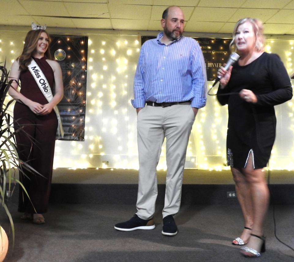 Miss Ohio Madison Miller and Mayor Mark Mills look on as Coshocton County Chamber of Commerce Director Amy Crown speaks at the recent chamber annual awards and banquet. Miller was recognized by Mills with a key to the city and proclamation.