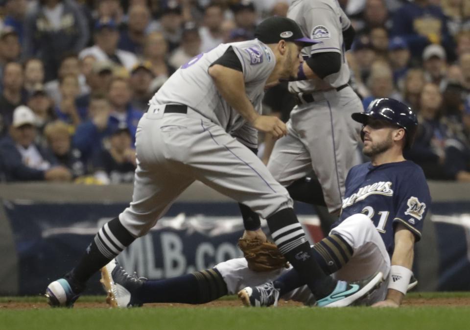 Colorado Rockies' Nolan Arenado tags out Milwaukee Brewers' Travis Shaw during the third inning of Game 2 of the National League Divisional Series baseball game Friday, Oct. 5, 2018, in Milwaukee. (AP Photo/Morry Gash)