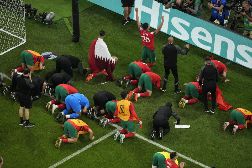 Moroccan players celebrate in front of their supporters after their win in the World Cup quarterfinal soccer match against Portugal, at Al Thumama Stadium in Doha, Qatar, Saturday, Dec. 10, 2022. (AP Photo/Thanassis Stavrakis)