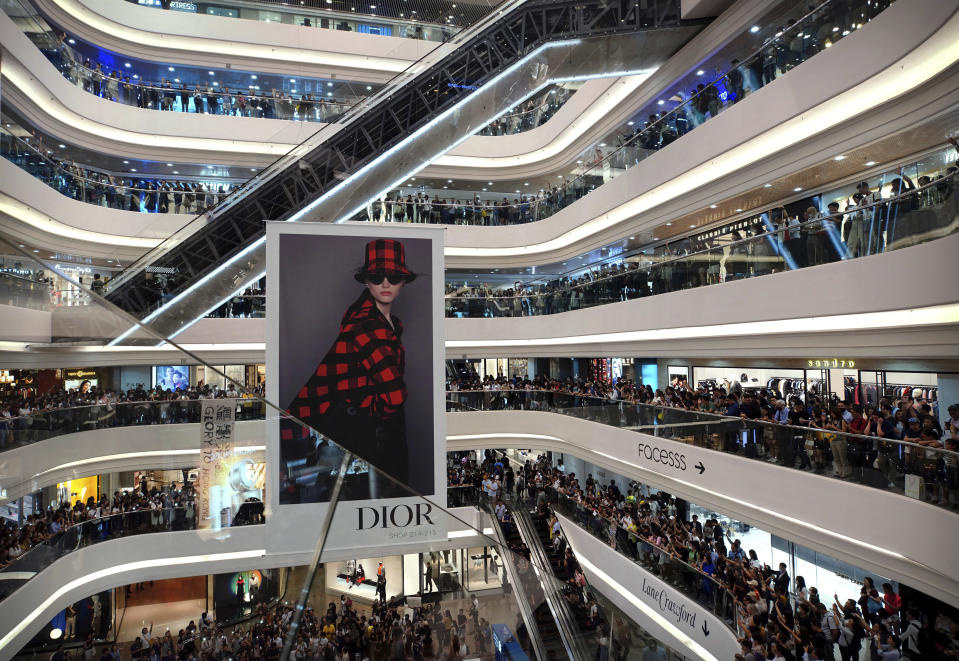 Demonstrators gather at the Times Square shopping mall in Hong Kong, Thursday, Sept. 12, 2019. Thousands of people belted out a new protest song at Hong Kong's shopping malls in an act of resistance that highlighted the creativity of demonstrators in their months-long fight for democratic freedoms in the semi-autonomous Chinese territory. (AP Photo/Vincent Yu)