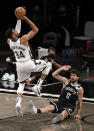 Milwaukee Bucks forward Giannis Antetokounmpo shoots over Brooklyn Nets forward Joe Harris (12) during the second half of Game 1 of an NBA basketball second-round playoff series Saturday, June 5, 2021, in New York. (AP Photo/Adam Hunger)