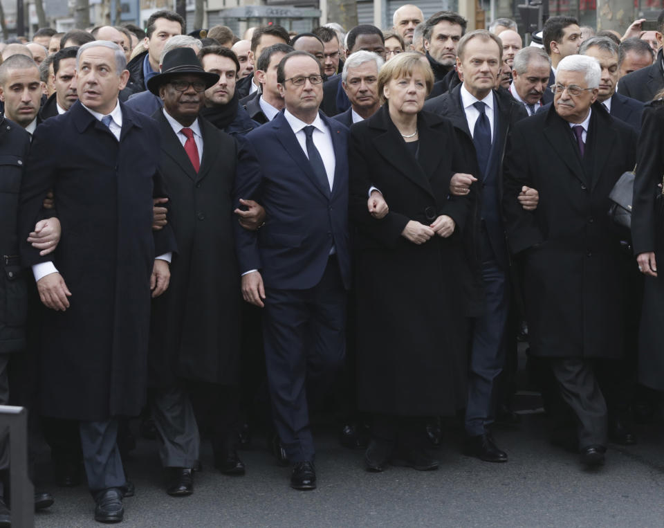 FILE - In this Jan. 11, 2015 file photo, from left : Israel's Prime Minister Benjamin Netanyahu, Mali's President Ibrahim Boubacar Keita, France's President Francois Hollande, Germany's Chancellor Angela Merkel, EU President Donald Tusk, and Palestinian President Mahmoud Abbas march during a rally in Paris. The January 2015 attacks against Charlie Hebdo and, two days later, a kosher supermarket, touched off a wave of killings claimed by the Islamic State group across Europe. Seventeen people died along with the three attackers. Thirteen men and a woman accused of providing the attackers with weapons and logistics go on trial on terrorism charges Wednesday Sept. 2, 2020. (Philippe Wojazer, Pool via AP, File)