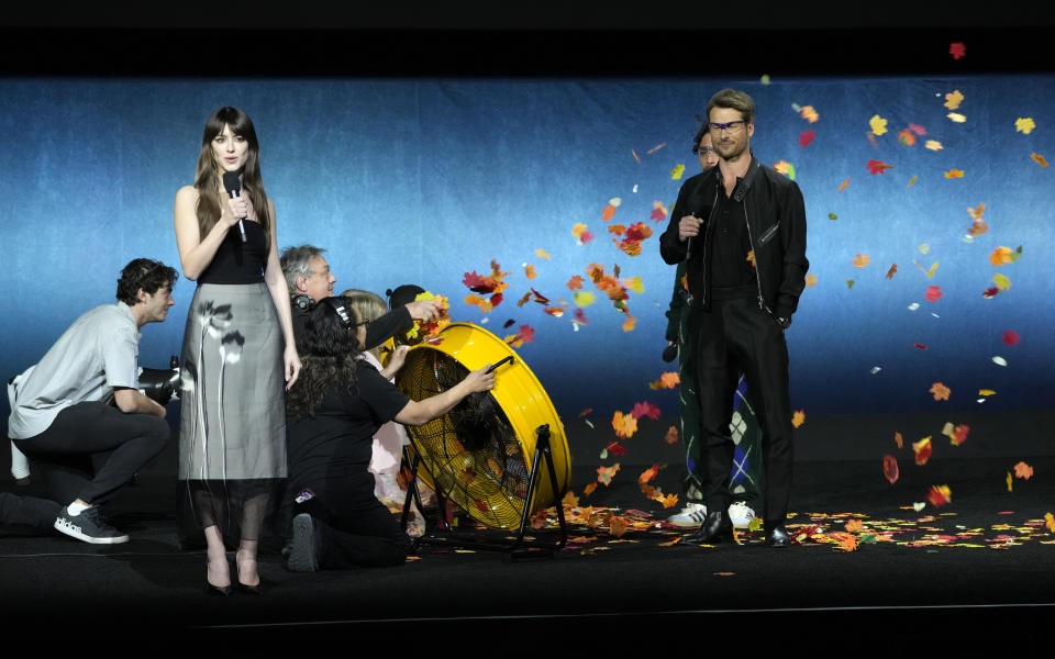 Daisy Edgar-Jones, left, a cast member in the upcoming film "Twisters," speaks to the audience as fellow cast member Glen Powell, right, faces a wind machine during the Universal Pictures and Focus Features presentation at CinemaCon 2024, Wednesday, April 10, 2024, at Caesars Palace in Las Vegas. (AP Photo/Chris Pizzello)