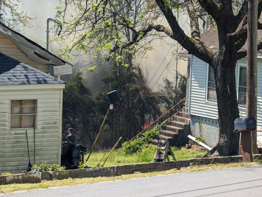 Brush fire burning behind homes on Dunklin Street and Low Avenue in Easley, S.C., April 15, 2024 (WSPA Photo)