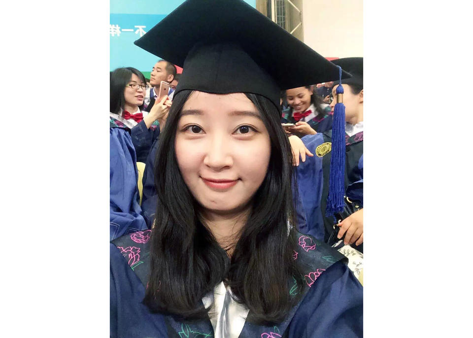 FILE - This 2016 selfie provided by her family shows Yingying Zhang in a cap and gown for her graduate degree in environmental engineering from Peking University Shenzhen Graduate School. The 26-year-old visiting scholar at the University of Illinois at Urbana-Champaign, disappeared June 9, 2017. Brendt Christensen, a former graduate student, has been charged with kidnapping and killing her. Zhang's body has not been found. (Zhang Family Photo via AP, File)