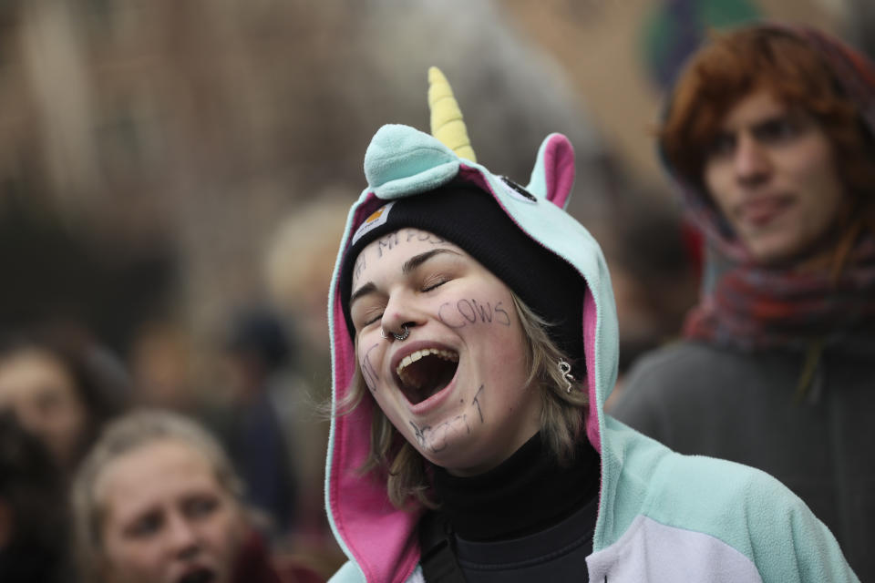 A young woman shouts slogans as she marches with others during a climate change protest in Brussels, Thursday, Jan. 31, 2019. Thousands of teenagers in Belgium have skipped school for the fourth week in a row in an attempt to push authorities into providing better protection for the world's climate. (AP Photo/Francisco Seco)