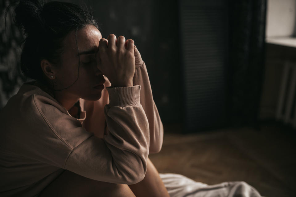 A person looking scared inside their room