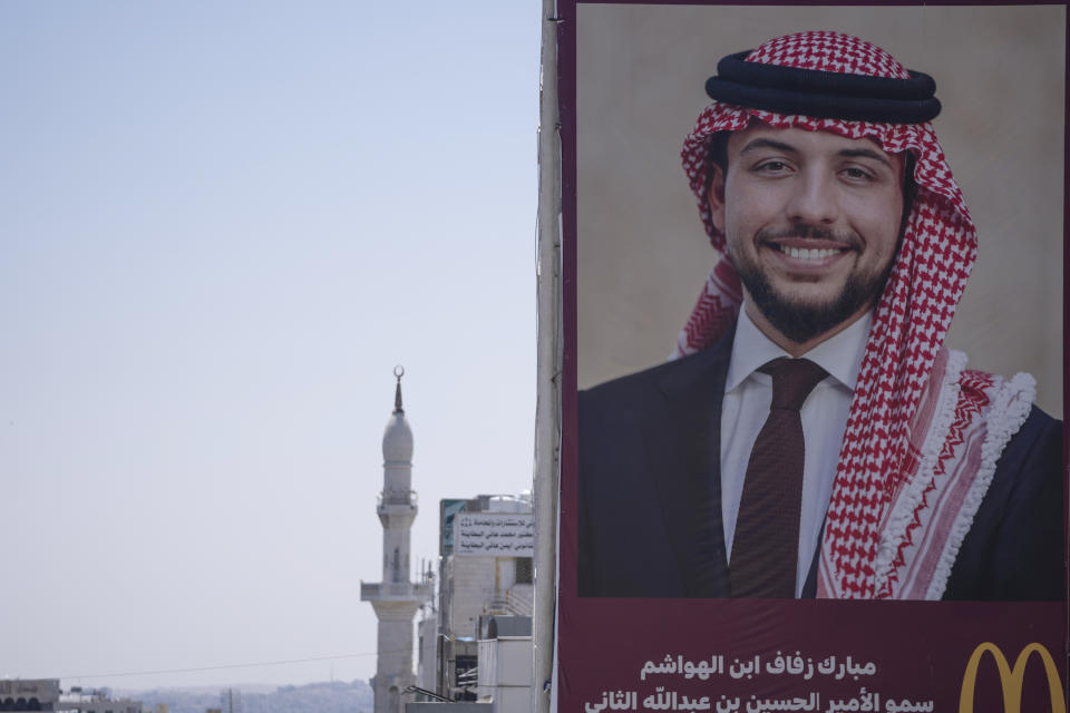 A poster with a picture of Crown Prince Hussein is posted at a road in Amman, Jordan, Wednesday, May 31, 2023. Crown Prince Hussein and Saudi architect Rajwa Alseif are to be married on Thursday at a palace wedding in Jordan, a Western-allied monarchy that has been a bastion of stability for decades as Middle East turmoil has lapped at its borders.(AP Photo/Nasser Nasser)