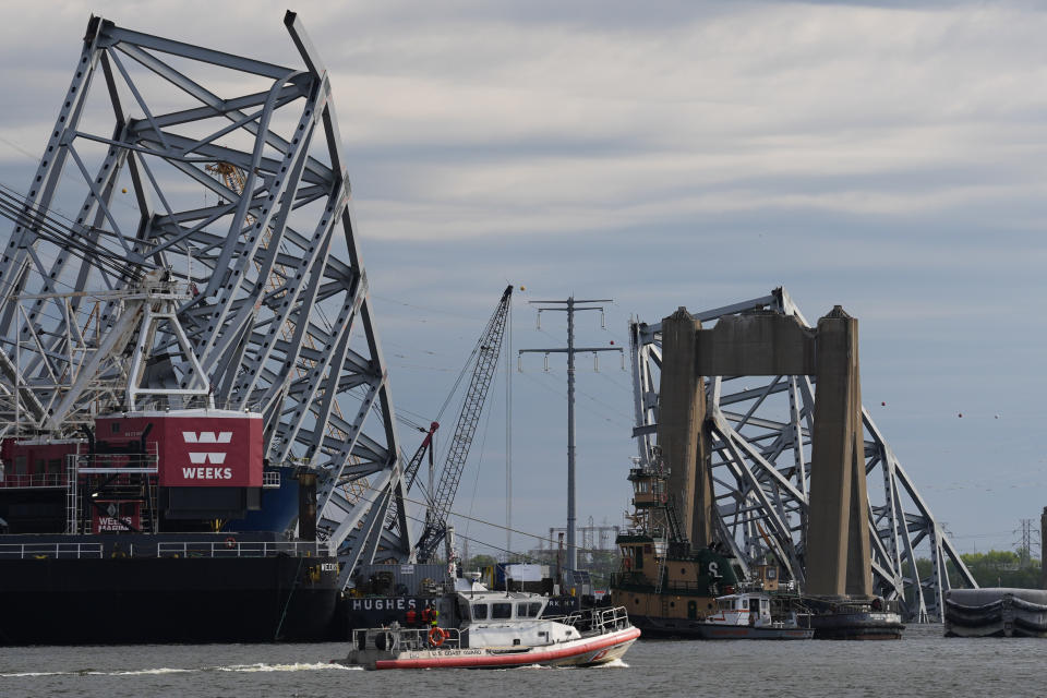 A Coast Guard vessel passes the collapsed Francis Scott Key Bridge, Thursday, April 25, 2024, in Baltimore. (AP Photo/Matt Rourke)