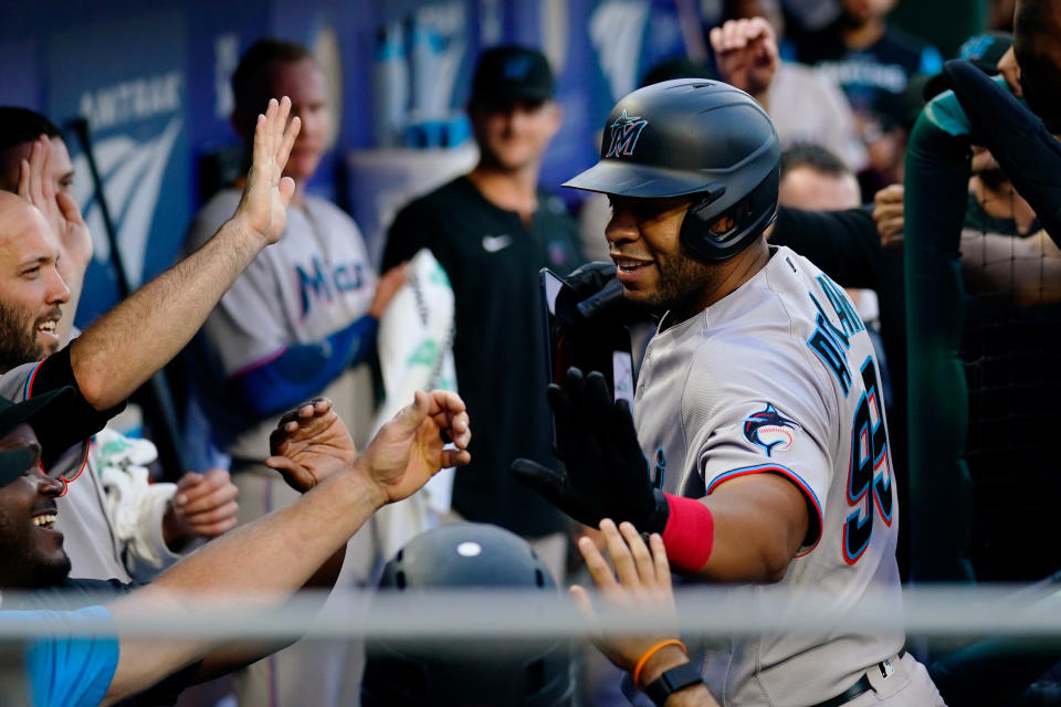 Miami Marlins' Keith Johnson celebrates with teammates after hitting a two-run home run off Philadelphia Phillies' Zach Eflin during the first inning of a baseball game Tuesday, June 14, 2022, in Philadelphia. (AP Photo/Matt Rourke)