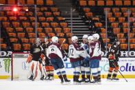 Colorado Avalanche players celebrate left wing Gabriel Landeskog's goal in the second period of an NHL hockey game against the Anaheim Ducks in Anaheim, Calif., Sunday, April 11, 2021. (AP Photo/Kyusung Gong)