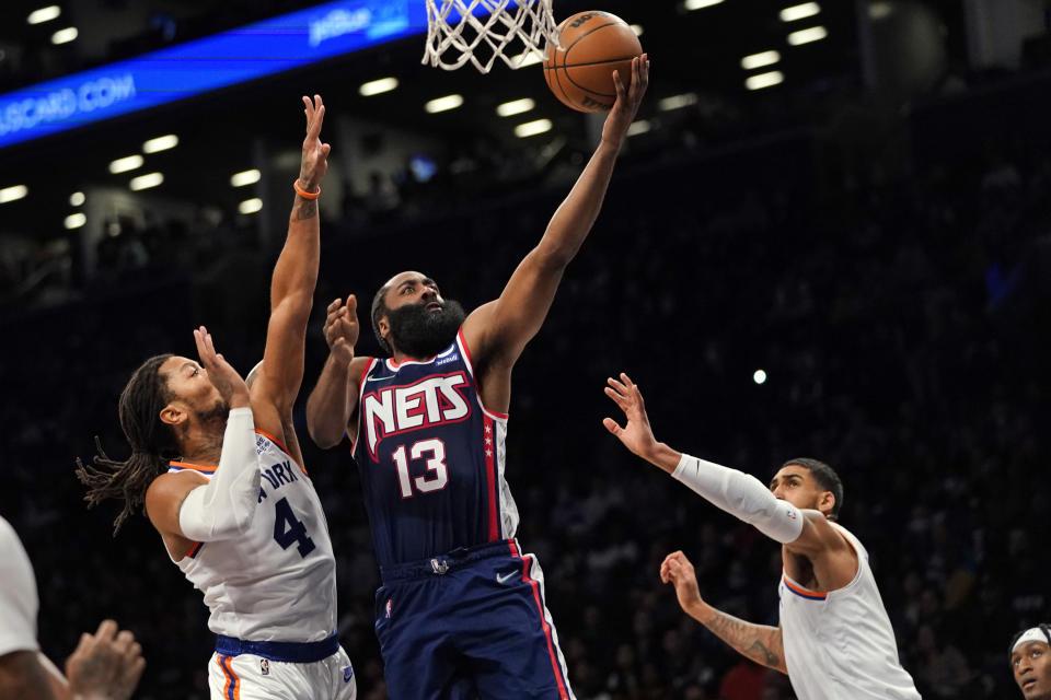 Brooklyn Nets guard James Harden (13) goes to the basket past New York Knicks guard Derrick Rose (4) during the second half of an NBA basketball game, Tuesday, Nov. 30, 2021, in New York. The Nets won 112-110. (AP Photo/Mary Altaffer)