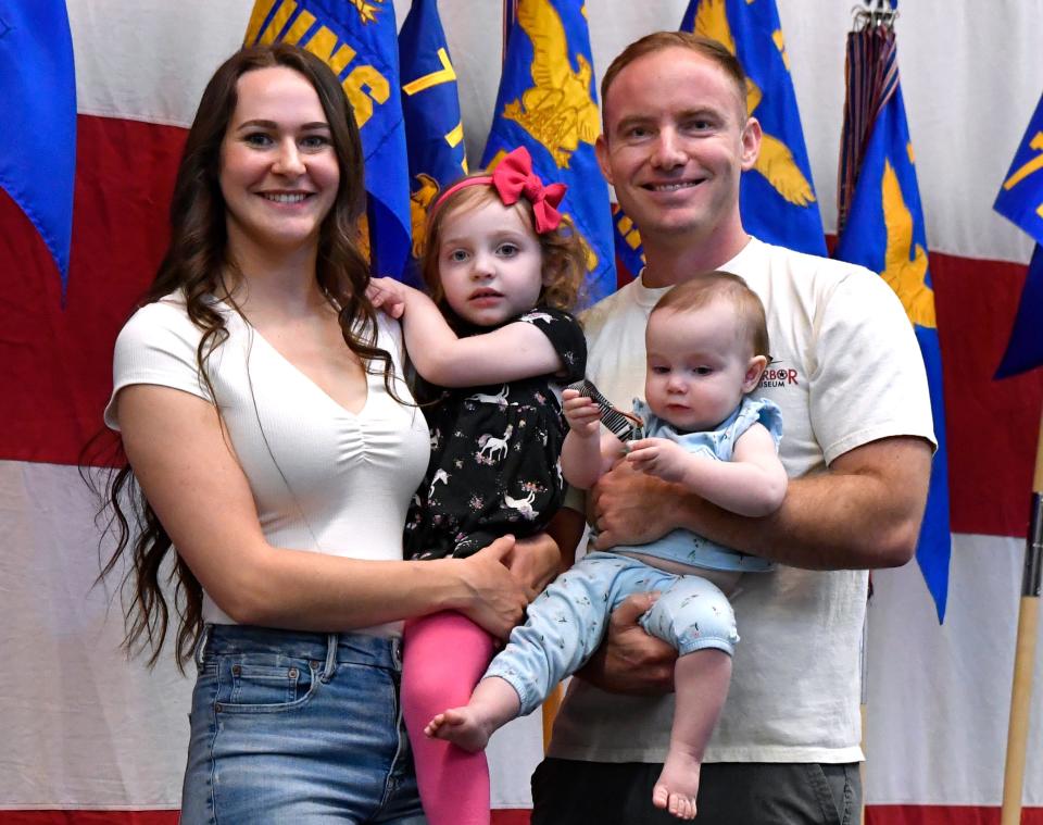 Colt Hoeptner holds his infant daughter Camilla, who's almost 1, as his wife Loresa carries their other daughter Collette, 3, after being named the Military Family of the Year during Saturday’s World’s Largest Barbecue at the Abilene Convention Center.