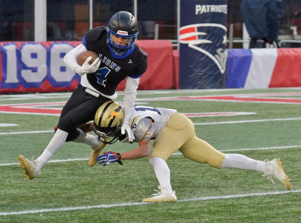 West Boylston’s John Ruas is tackled by St. Bernard’s Damien Jones in the second quarter during the Division 7 Super Bowl at Gillette Stadium Friday, December 2, 2022.