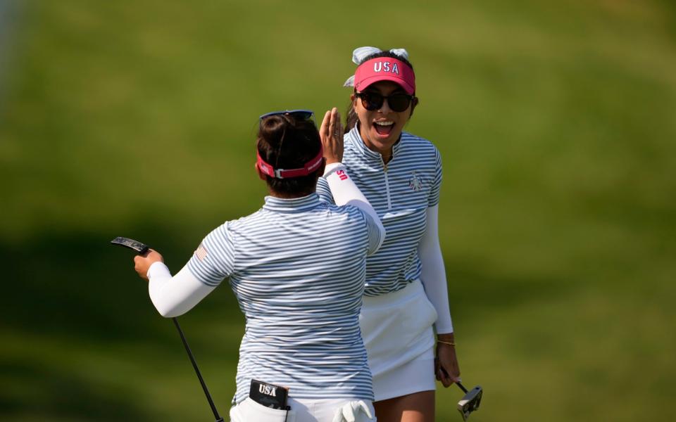 United States' Megan Khang is congratulated by teammate Alison Lee after making a putt on the 11th hole