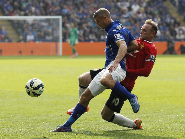 Leicester City defender Paul Konchesky (L) and Manchester United's Wayne Rooney during their Premier League match at the King Power Stadium on September 21, 2014