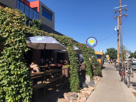 Customers sit in the Denver Beer Co. brewery's taproom in Denver