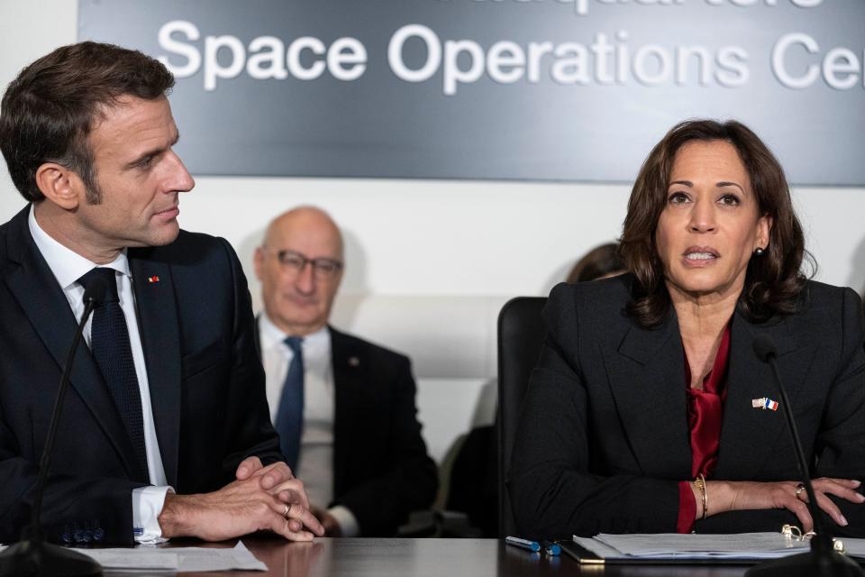 French president Emmanuel Macron, left, and vice president Kamala Harris speak during a meeting to highlight space cooperation between the two countries, at Nasa headquarters in Washington, Wednesday, 30 November 2022 (AP)