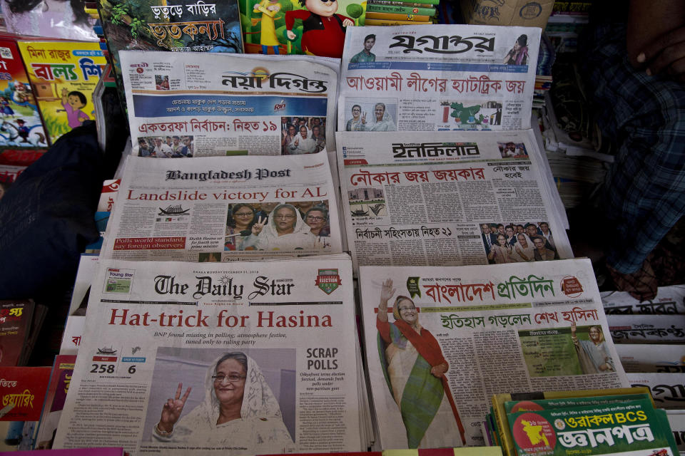 Newspapers are displayed in a shop a day after general elections in Dhaka, Bangladesh, Monday, Dec. 31, 2018. Bangladesh's ruling alliance won virtually every parliamentary seat in the country's general election, according to official results released Monday, giving Prime Minister Sheikh Hasina a third straight term despite allegations of intimidation and the opposition disputing the outcome. (AP Photo/Anupam Nath)