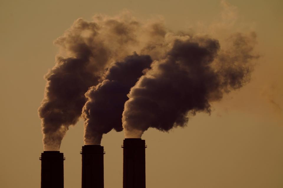 Emissions rise from the smokestacks at the Jeffrey Energy Center coal power plant as the suns sets, near Emmett, Kansas, on Sept. 18, 2021.