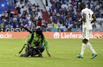 Germany's Antonio Ruediger, right, walks towards a protestor who landed on the pitch before the Euro 2020 soccer championship group F match between France and Germany at the Allianz Arena stadium in Munich, Tuesday, June 15, 2021. (Matthias Hangst/Pool via AP)