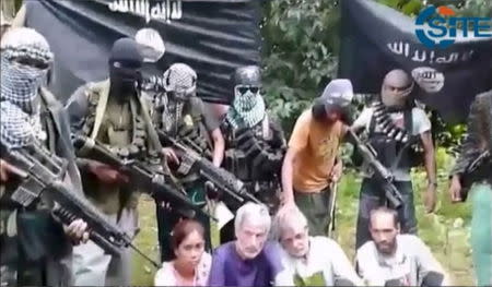 A still image captured from video footage of Philippine jihadis and kidnap victims is shown in this SITE Intelligence Group video made available to Reuters on October 13, 2015. REUTERS/SITE Intelligence Group/Handout via Reuters