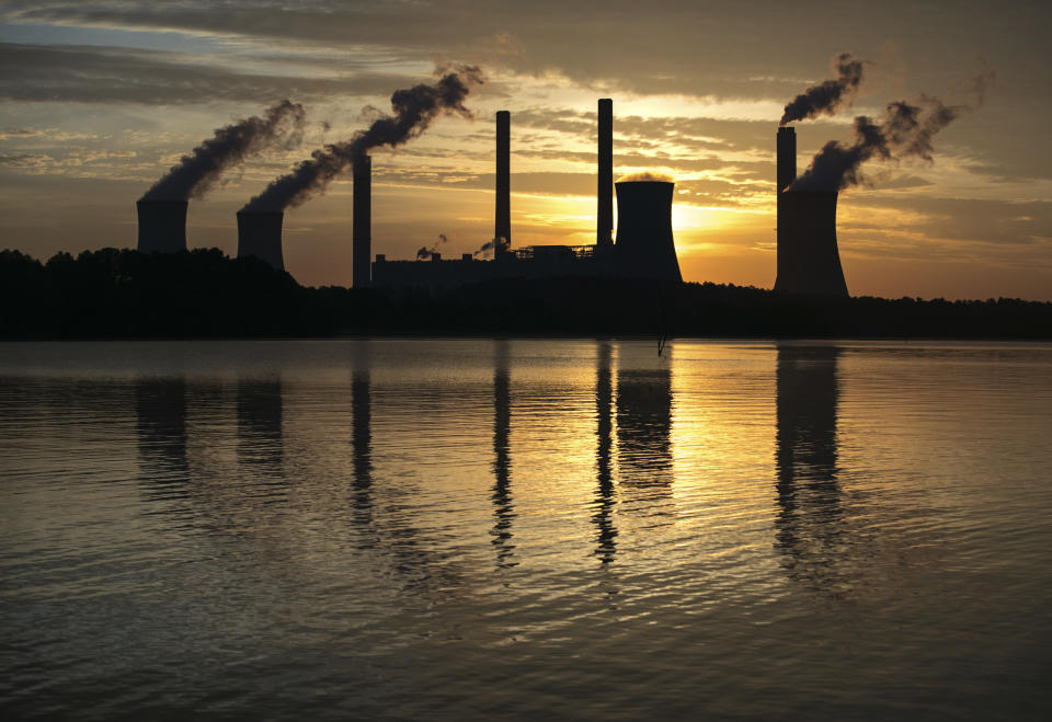 FILE - In this June 3, 2017, file photo, the coal-fired Plant Scherer, one of the nation's top carbon dioxide emitters, stands in the distance in Juliette, Ga. Global carbon dioxide emissions related to energy use are being forecast to rise significantly this year, driven by a resurgence in the use of coal to generate electricity, the International Energy Agency says. The IEA’s report Tuesday, April 20, 2021, says that worldwide energy-related carbon dioxide emissions are on track to surge by 1.5 billion metric tons this year, following last year’s decline due to the coronavirus pandemic. (AP Photo/Branden Camp, File)