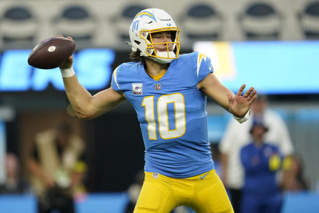 Los Angeles Chargers quarterback Justin Herbert (10) adjusts his helmet as  he warms up before an NFL football game against the Seattle Seahawks Sunday,  Oct. 23, 2022, in Inglewood, Calif. (AP Photo/Marcio