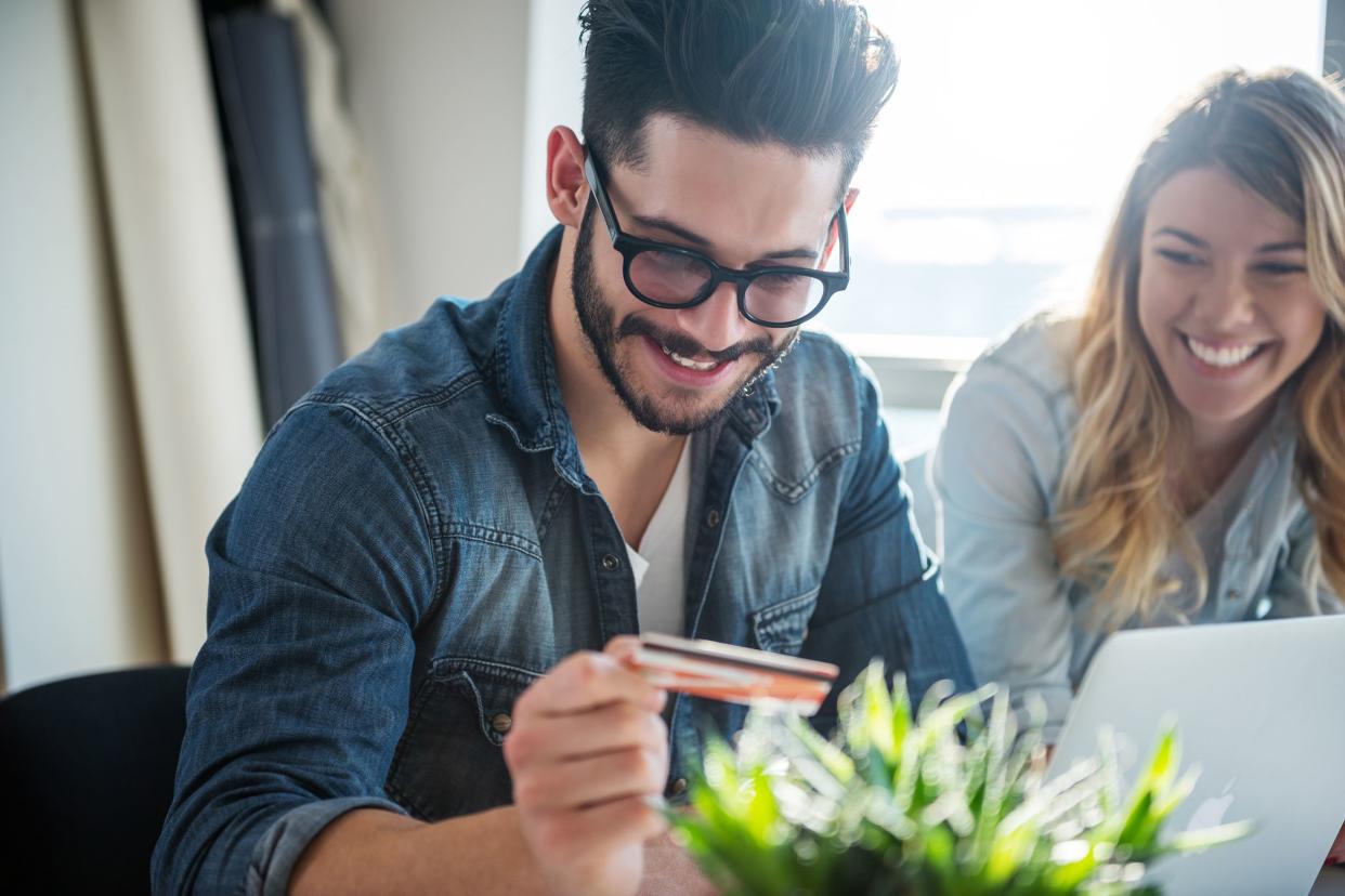 young man and woman ordering online with a credit card