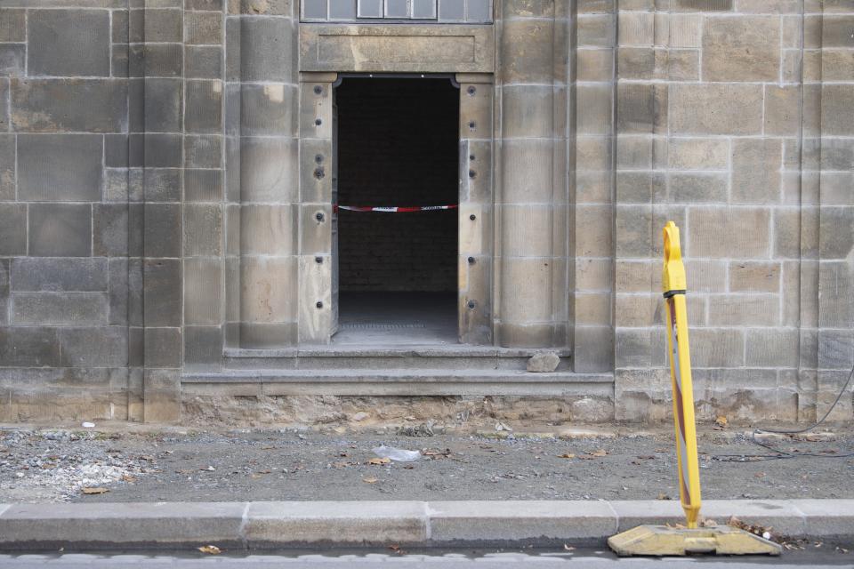 A caution tape is fixed at the entrance to catacombs under the August Bridge, where a fire destroyed the power supply for the State Art Collection with the Green Vault in Dresden, Germany, Monday, Nov. 25, 2019. Authorities in Germany say thieves have carried out a brazen heist at Dresden’s Green Vault, one of the world’s oldest museum containing priceless treasures from around the world. (Sebastian Kahnert/dpa via AP)