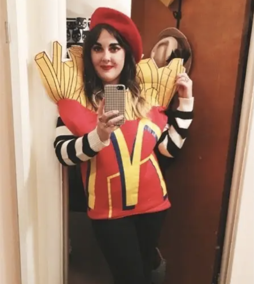 A woman dressed as McDonald's French fries while wearing a barrette and striped shirt