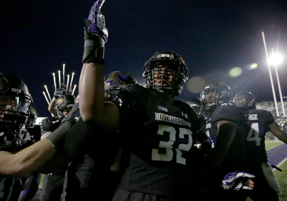 Northwestern linebacker Nate Hall celebrates with teammates after intercepting a pass from Michigan State quarterback Brian Lewerke in triple overtime in 2017. (AP)