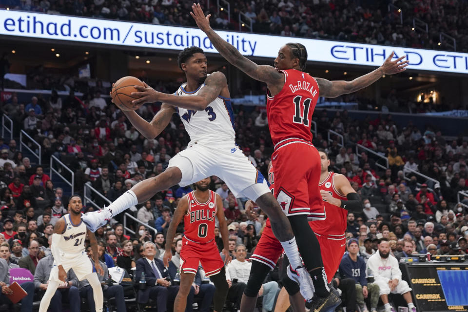 Washington Wizards guard Bradley Beal (3) passes the ball past Chicago Bulls forward DeMar DeRozan (11) during the second half of an NBA basketball game, Friday, Oct. 21, 2022, in Washington. (AP Photo/Jess Rapfogel)