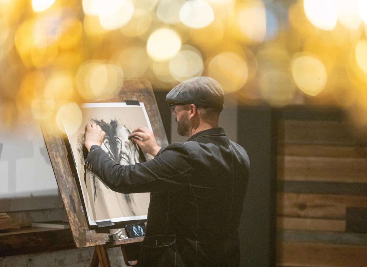 Bruce Budd, director of operations at The Nook Smokehouse & Grille in the Massillon area, works on a charcoal drawing recently during restaurant hours. Budd's live artwork makes eating at The Nook a unique experience.