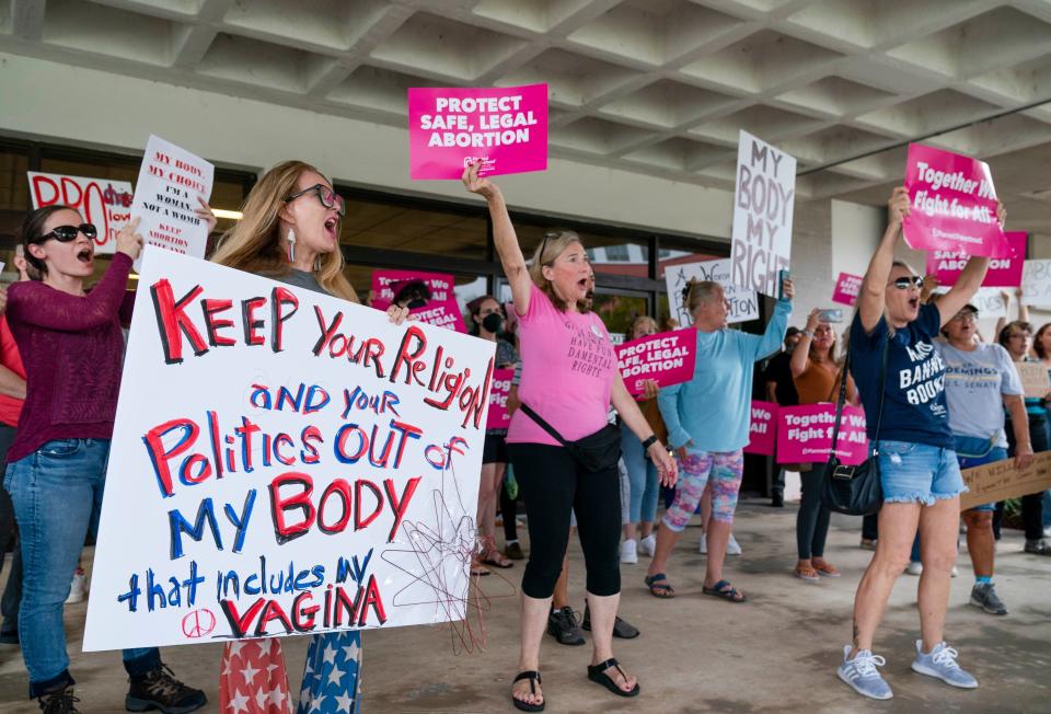 Protesters demonstrate in front of the Paul G. Rogers Federal Building and U.S. Courthouse last year in West Palm Beach, Florida.
