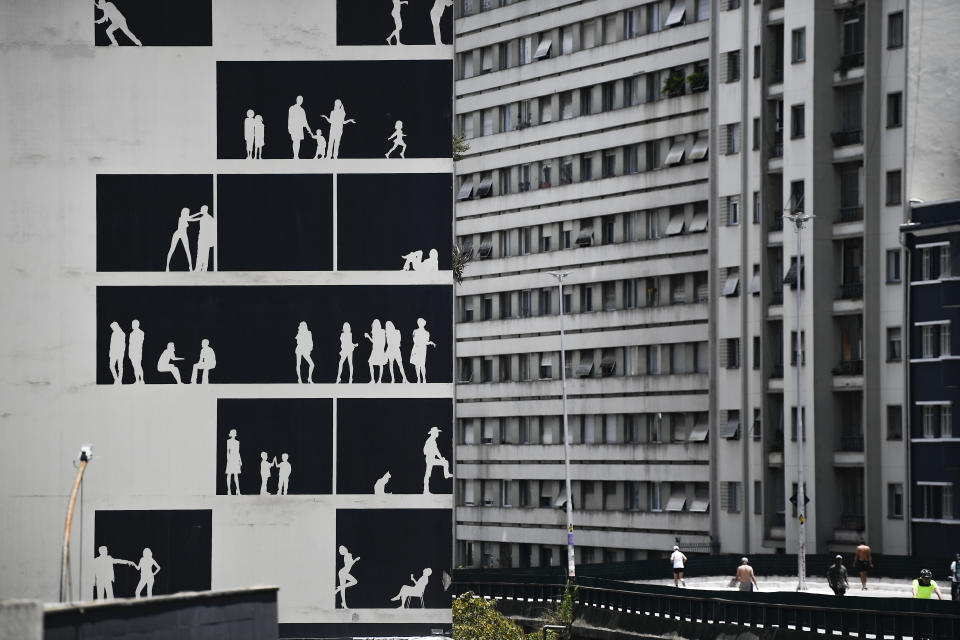 A full-scale monochrome mural by the Brazilian architect studio Nitsche Arquitetos adorns a “blind wall”, near Minhocao Park in Sao Paulo, Brazil, Saturday, Oct. 29, 2022. On Sunday, Brazilians head to the voting booth to choose between the top two presidential candidates who are facing each other in a runoff vote after neither got enough support to win outright in the Oct. 2 general election. (AP Photo/Matias Delacroix)