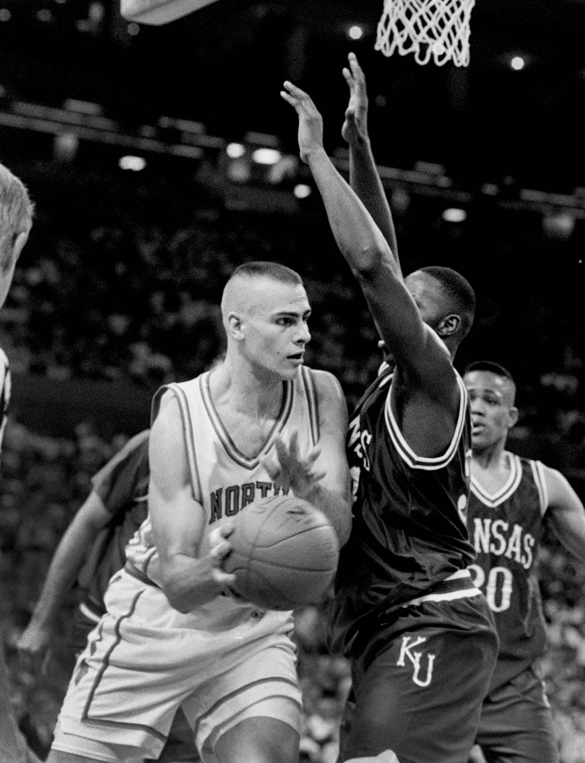 UNC center Eric Montross passes around a Kansas defender in the semis of the Final Four in New Orleans in 1993.