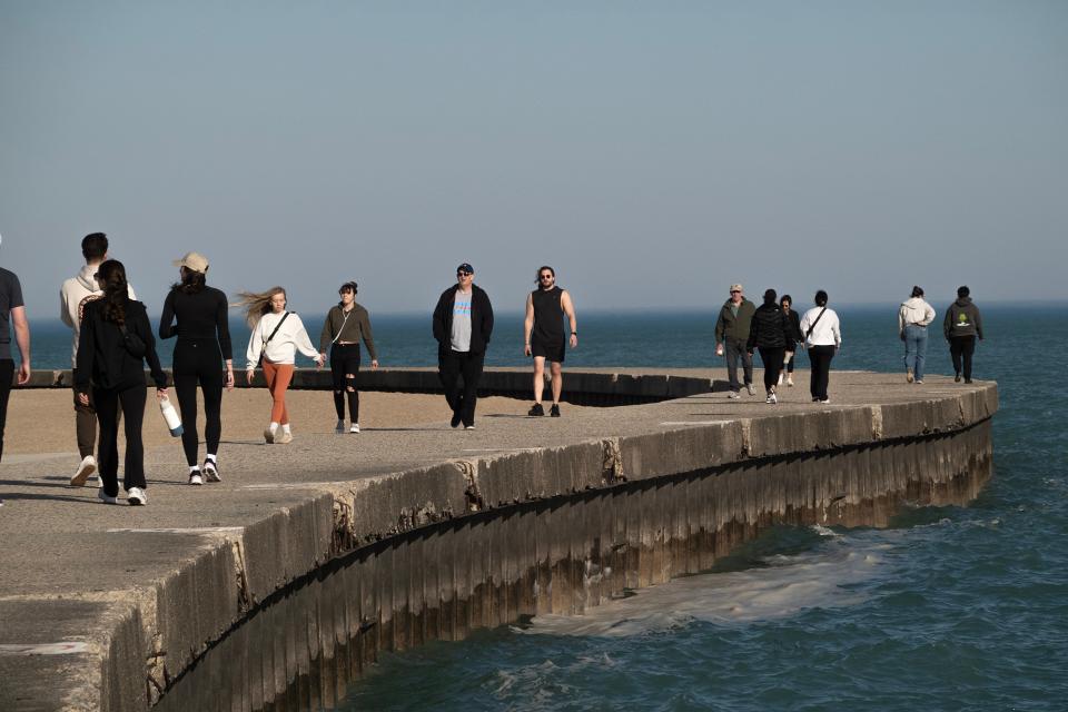 People walk along a boardwalk on a spring-like February day in Chicago (Getty Images)