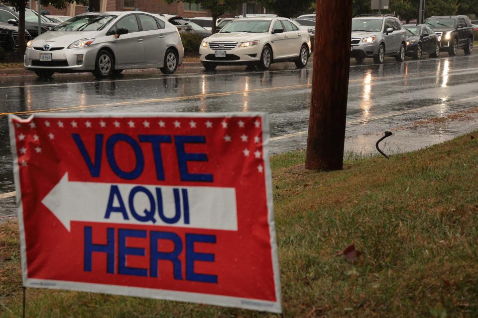 MCLEAN, VIRGINIA - OCTOBER 29: Cars line up along Balls Hill Road waiting to enter the McClean Government Center during early voting on October 29, 2021 in McLean, Virginia. Recent polls indicate the governors race in Virginia is a a dead heat between Democrat Terry McAuliffe and Republican Glenn Youngkin.