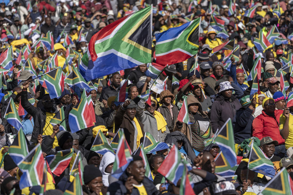 FILE - South Africans cheer ahead of the inauguration of South Africa's Cyril Ramaphosa as President at the Union Buildings South Lawns in Pretoria, South Africa, on June 19, 2024. In a country where racial segregation was once brutally enforced, South Africa's new coalition government has brought a Black president and a white opposition leader together in what is on the face of it a picture of unity. (AP Photo/Jerome Delay, File)