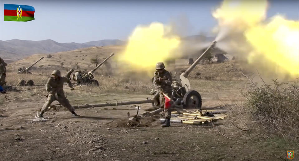 In this image taken from video released by Azerbaijan's Defense Ministry on Tuesday, Oct. 20, 2020, Azerbaijan army soldiers fire an artillery piece during fighting with forces of the self-proclaimed Republic of Nagorno-Karabakh. Azerbaijan Defense Ministry claims that Armenian forces tried to carry out an offensive that was met by an artillery strike from Azerbaijan, causing a large number of casualties among Armenian forces. (Azerbaijan's Defense Ministry via AP)