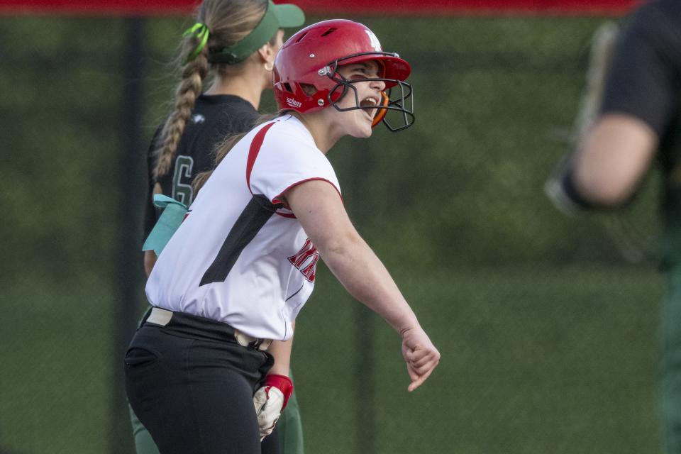 New Palestine High School freshman Payton Dye (12) reacts after hitting a double during an IHSAA softball game against Zionsville High School, Friday, April 19, 2024, at New Palestine High School. New Palestine won, 6-1.