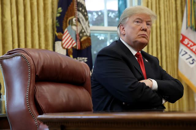 <p>Win McNamee/Getty Images</p> Former President Donald Trump sits in the Oval Office on Oct. 10, 2018