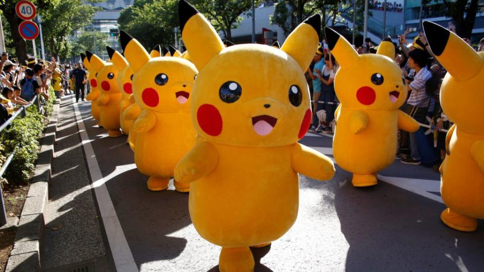 Performers wearing Pokemon's character Pikachu costumes take part in a parade in Yokohama