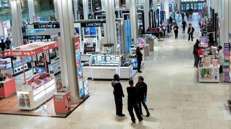 FILE PHOTO: Workers wait for customers at Macy's store during the outbreak of coronavirus disease (COVID-19), in New York City,