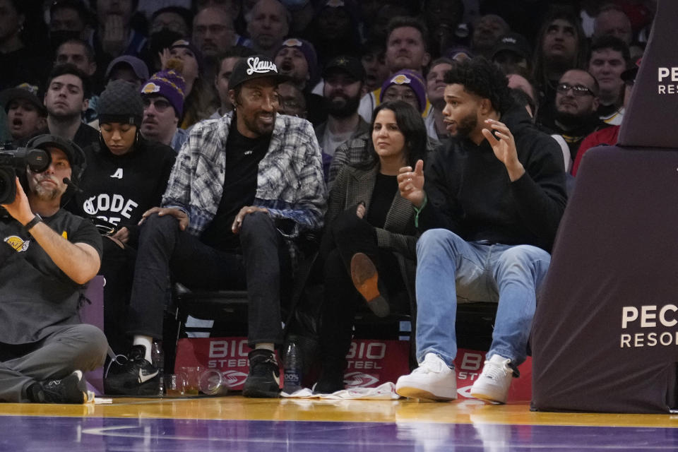 Former NBA players Miles Bridges, right, and Scottie Pippen, second from left, talk during the second half of a basketball game between the Los Angeles Lakers and the Charlotte Hornets on Friday, Dec. 23, 2022, in Los Angeles. (AP Photo/Marcio Jose Sanchez)