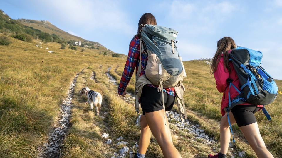 Two women hiking with backpacks