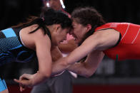 <p>Belarus' Vasilisa Marzaliuk (red) wrestles China's Zhou Qian in their women's freestyle 76kg wrestling repechage match during the Tokyo 2020 Olympic Games at the Makuhari Messe in Tokyo on August 2, 2021. (Photo by Jack GUEZ / AFP)</p> 