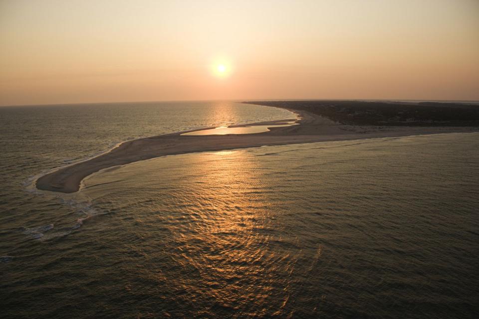aerial view of sun over atlantic ocean and shoreline of bald head island, north carolina